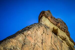 A rock formation with a hole in the side photo