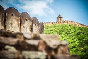 A stone wall with a tower on top of it photo