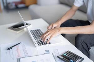 Business man working using laptop computer Hands typing keyboard. Professional investor working start up project. business planning in office. Technology business Concept photo