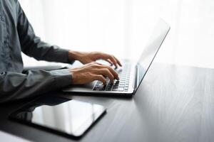 Business man working with laptop Hands typing keyboard. Professional investor working new start up project. business planning in office. Technology business.. photo