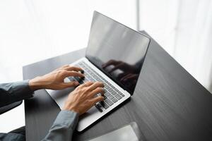 Business man working with laptop Hands typing keyboard. Professional investor working new start up project. business planning in office. Technology business.. photo