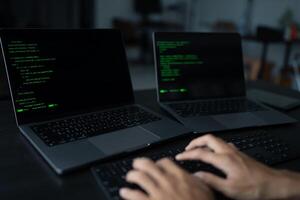 Asian man software engineer Working on Computer at office desk for writing program code IT Software Engineer finding errors tech support devops creating digital photo