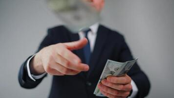 Formally dressed man carelessly throws US Dollar bills towards the camera video