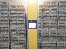 Hatching eggs in modern incubator hatchering machine, A newborn chicken is knocked out of an eggs ,brood of small chicks. High Technology of newborn chicken production. photo