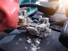 Terminal battery broken,The white powder that is on the head of the car battery is a fungus that appears due to an alternator overcharge which can cause overheating at the positive pole. photo