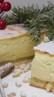 Cheese pancake, cheesecakes with powdered sugar, jam, and mint on a brown plate. New Year's baking on the background of the Christmas tree video