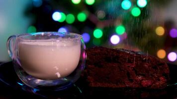 milk in glass sprinkle brownie with powdered sugar chocolate cookies on a black plate with a sprinkle of powdered sugar on top. Concept of indulgence and warmth, as the cookies are a delicious treat video