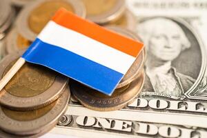 Stack of coins with Netherlands flag and US dollar banknotes. photo