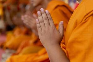 In the morning the monks walk for alms with the Buddhists, offering food to the monks with devotion. photo