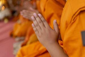 In the morning the monks walk for alms with the Buddhists, offering food to the monks with devotion. photo