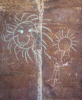 Children's drawing with chalk on a metal tin photo