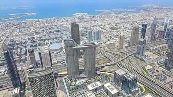 Dubai OAE 20.10.2024 Aerial view of modern Dubai skyline with coastal backdrop. A stunning aerial view of Dubai modern skyline featuring towering skyscrapers and a complex highway network. video
