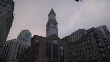 The buildings lined up along Purchase Street in Downtown Boston create a striking scene, set against the monumental backdrop of the Custom House Tower. video