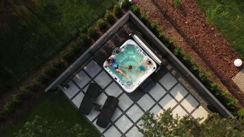 The family swims in a bubble pool in their courtyard. View from above video
