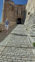 Approach to the historic city gate of Bonifacio in Corsica ending with a panoramic view of the surrounding cliffs video