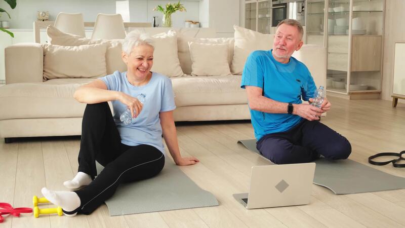Yoga mindfulness water. Senior adult mature couple drinking water after practicing yoga with online lessons in laptop. Old wife husband drink water before workout. Family doing sports exercise at home 52191182 Stock Video at Vecteezy