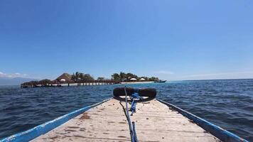 Tranquil boat ride across crystal waters heading to Kenawa Island in Sumbawa Indonesia showcasing serene ocean views and lush island scenery in the distance. video