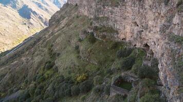 Aerial fly over view Horomayr Monastery monastic complex in the Lori Province of Armenia, Odzun village. Monastery nestled amongst rock and cliff escarpments with caves for protection video