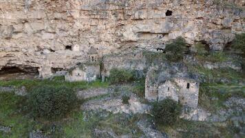 Aerial zoom out view Horomayr Monastery monastic complex in the Lori Province of Armenia, Odzun village. Monastery nestled amongst rock and cliff escarpments with caves for protection video