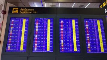 Departure board screen, flight schedule, flight cancellation, or flight delay in Don Mueang International Airport. video