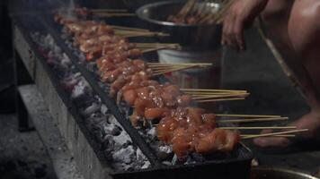 The process of making Indonesian chicken satay in traditional way using charcoal. video