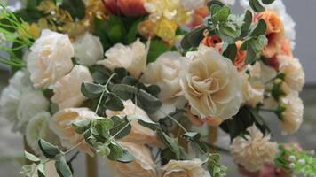 Fancy wedding reception table setting with flower arrangements on top and outdoor background. video