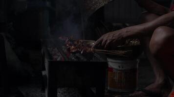 The process of making Indonesian chicken satay in traditional way using charcoal. video