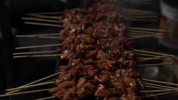 The process of making Indonesian chicken satay in traditional way using charcoal. video