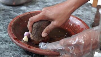 Traditional Indonesian sauce named sambal bawang in the making using traditional tool. video