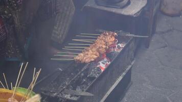 The process of making Indonesian chicken satay in traditional way using charcoal. video