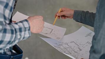 A man is gesturing at a drawing on paper with a pencil video
