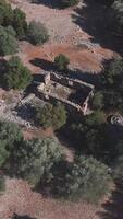 An aerial view of an old stone building surrounded by trees video
