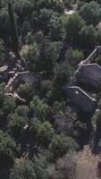 An aerial view of an old stone building surrounded by trees video