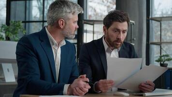 Nervous angry man boss argue scolds employee because mistake in documents financial papers Caucasian men businessmen arguing in office meeting business conflict problem mistake work failure bad result video