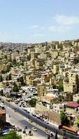 A panoramic view of a vibrant cityscape with rolling hills and unique architecture. Action video