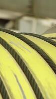 Coiled Industrial Yellow Rubber Hose Stored in a Warehouse Environment for Easy Access and Use. Stock Clip video