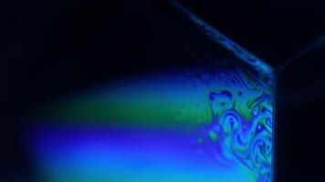 Bright rainbow reflection of liquid in macro, white colors, surrealistic background, fantastic smooth movement video