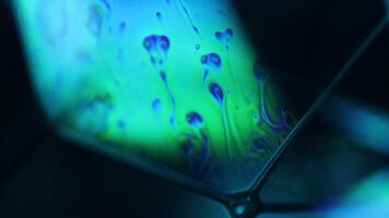 Bright rainbow reflection of liquid in macro, white colors, surrealistic background, fantastic smooth movement video