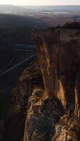 An impressive aerial view of a group of high rocks in summer. Shot. Natural landscape with wild rock formations covered by green plants with mountainous valley on the background. video
