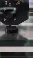 Automatic device 3D printer prints the form of molten plastic. HDR. Close up of modeling a black plastic detail with a 3D printer, progressive design technology concept. video