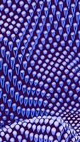 Canvas waves of small spheres. Design. 3d metallic glowing beads moving up and down. video