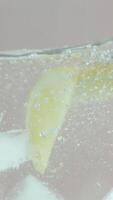 The freshness of lemon slices in clear water, closeup. Action. Citrus natural drink with a lot of vitamin c, concept of healthy and fresh beverages. video