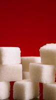 Pile of sugar cubes on isolated background. Stock footage. Pile of sugar cubes changes in number on isolated background. Sweets in large quantities are harmful to health. Sugar and sweets are 21st video