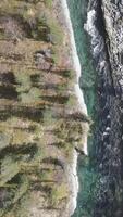 Aerial top view of a blue cold river flowing through summer green forest and stones. Clip. Nature landscape with stone mountainous stream and trees. video