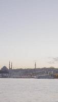 Timelapse of boats sailing to Istanbul. Action. Beautiful view of harbor with passing boats and bridge on background of coast with mosques. Coast with mosques on background of twilight video