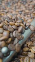 Close-up of coffee beans stirred and roasted. Action. Special machine mixes coffee beans for thermal processing. Roasting coffee in machine video
