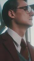 Portrait of a handsome young clever scientist in a classic suit looking pensively through the window and walking away. Stock footage. Academician in a retro scene. video