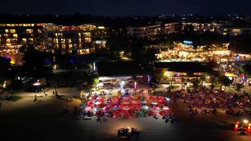 Bali, Indonesia - October 12th 2024 Aerial view of tropical beach and island at night, kuta beach seminyak bali video