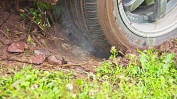car tire slipping while stuck in a dirt, closeup video