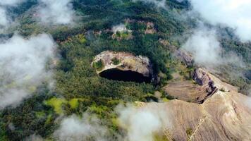 Experience the mesmerizing of Kelimutu's Three Color Lake in Ende. Wrapped in mystical clouds, this magical site, rich in legend, offers a breathtaking landscape that captivates the soul. video